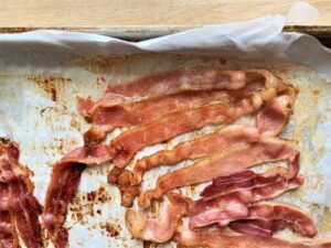 cooked bacon on baking sheet for potato salad