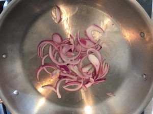 red onions in pan