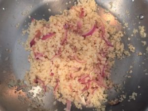 red onion and cauliflower in pan