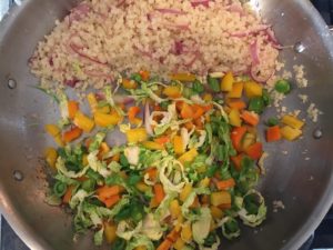 riced cauliflower, red onions and vegetables in pan